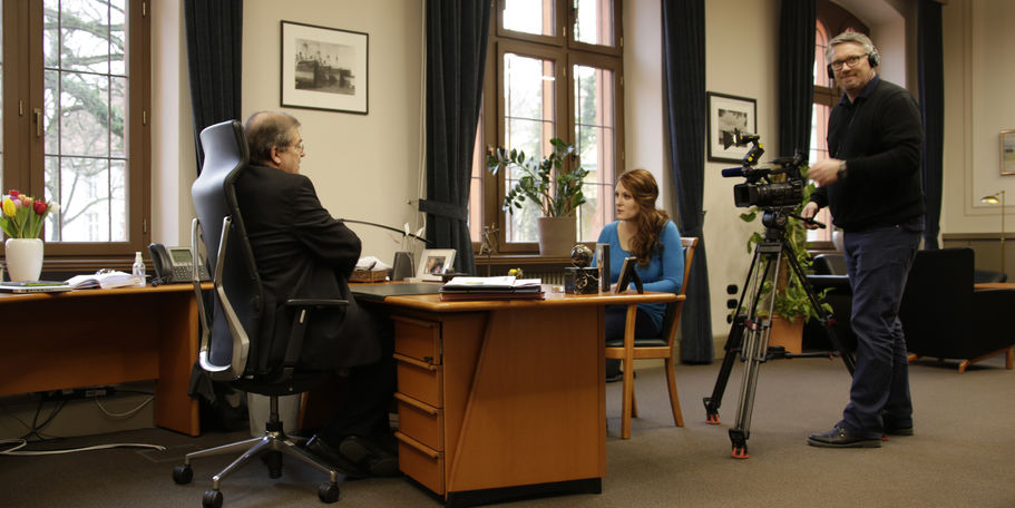 Mit Blick auf den Universitätsplatz: Rektor Prof. Dr. Wolfgang Schareck im Interview mit Konstanze Schöne vom Lokalsender TV.Rostock. © 2016 Betrieb für Bau und Liegenschaften Mecklenburg-Vorpommern