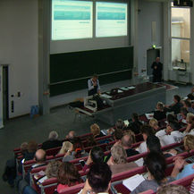 Christiane Schwark vom BBL M-V spielt hier am 28. April 2016 im Hörsaal der Schiffstechnik der Universität Rostock das Verfahren als Bieter anschaulich durch.
Rechts neben dem Rednerpult: Michael Reith von der Firman RIB aus Berlin. © 2016 Betrieb für Bau und Liegenschaften Mecklenburg-Vorpommern