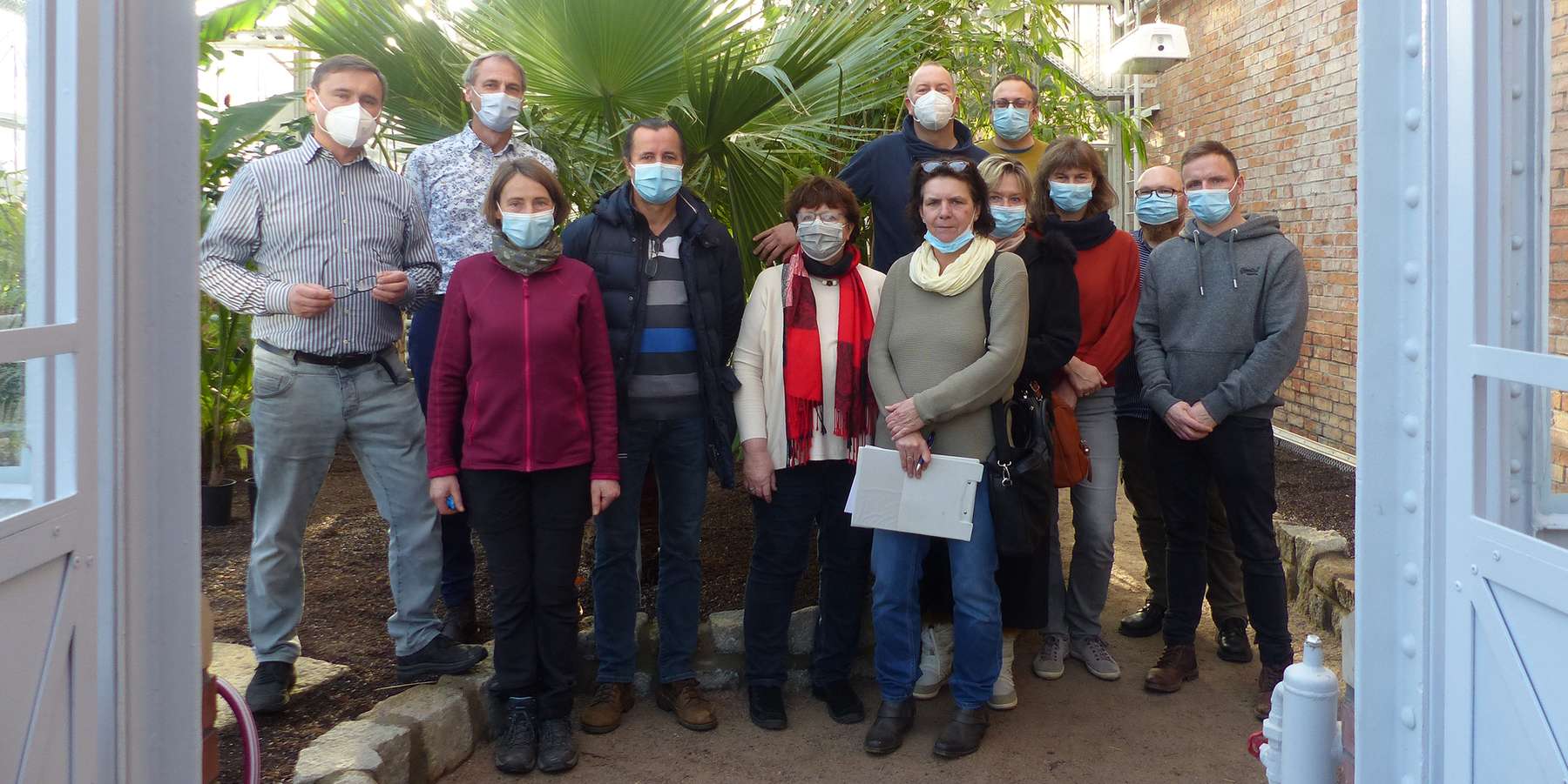 Gruppenbild unter Palmen  mit den anwesenden Vertretern der Universität, des SBL Greifswald sowie der beteiligten Planungsbüros © 2021 SBL Greifswald