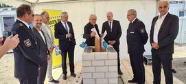 Befüllen der Zeitkapsel: Gunnar Mächler, Leiter Führungsstab im Polizeipräsidium Neubrandenburg, Neubrandenburgs OB Witt, Landrat Kärger, Stefan Wenzl, Jens Rott, Minister Pegel, Inspekteur der Polizei in Mecklenburg-Vorpommern Hoffmann-Ritterbusch u. Arc © 2024 Staatliches Bau- und Liegenschaftsamt Neubrandenburg