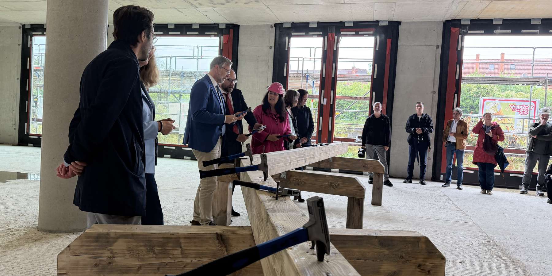 Symbolisch werden die letzten Nägel eingeschlagen. © 2026 SBL Rostock